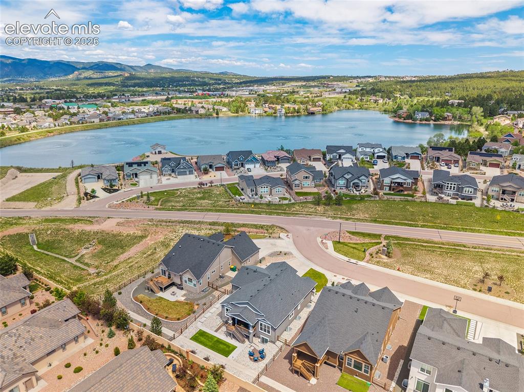 Image 44 of 46: Aerial perspective showcasing a residential community with a prominent body