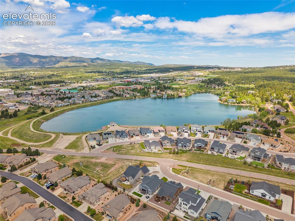 Image 45 of 46: Aerial perspective showcasing a serene lake surrounded by residential prope