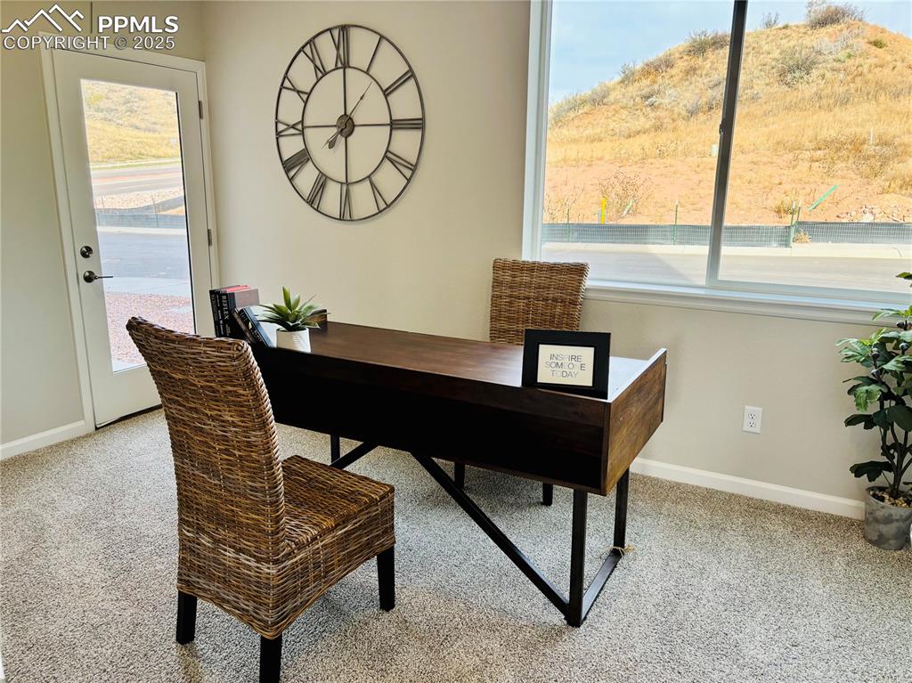 Image 12 of 14: Office area with light carpet and healthy amount of natural light