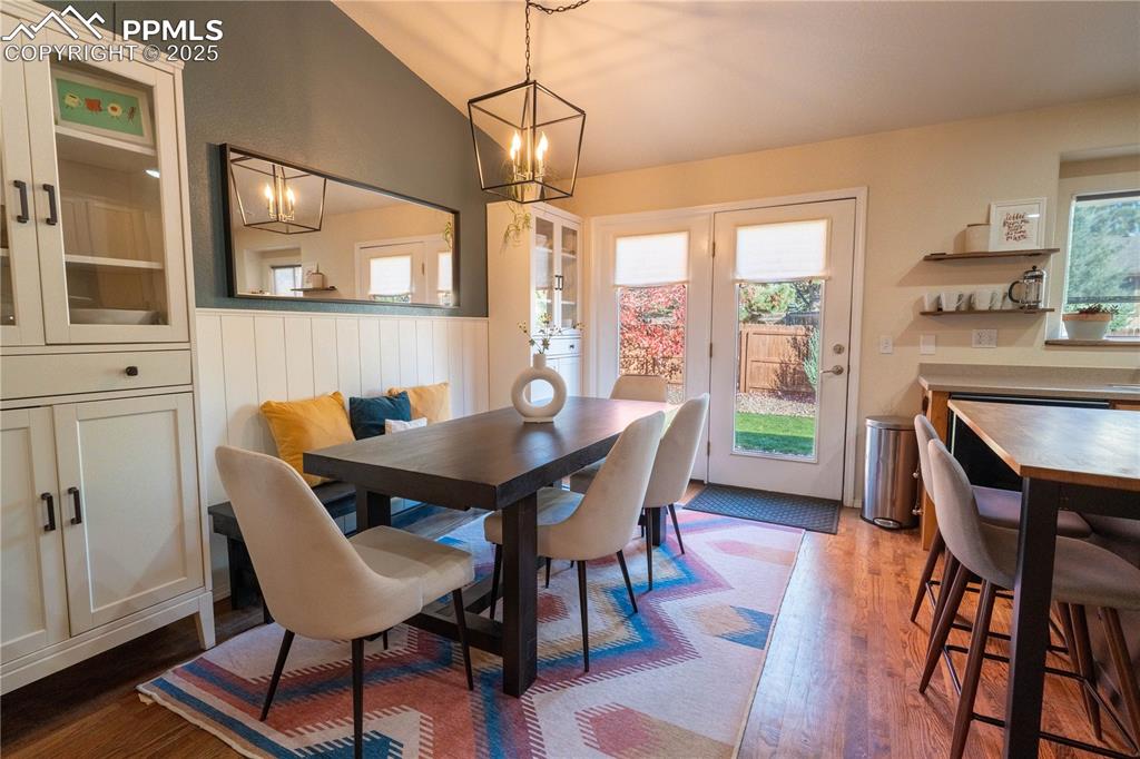 Image 16 of 26: Dining room featuring dark wood-style floors, plenty of natural light, and