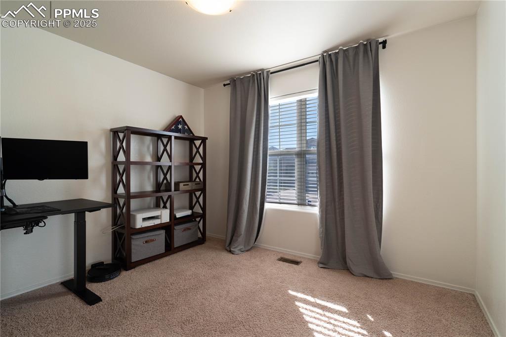 Image 4 of 26: Office area featuring light carpet and baseboards
