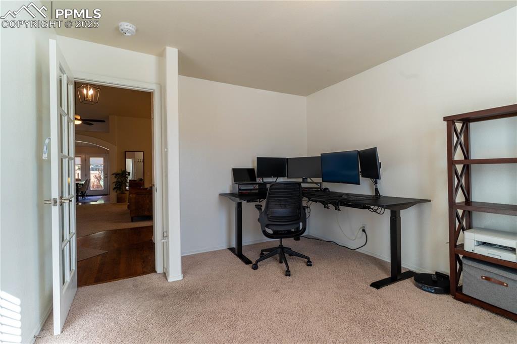 Image 5 of 26: Office area featuring light colored carpet and french doors