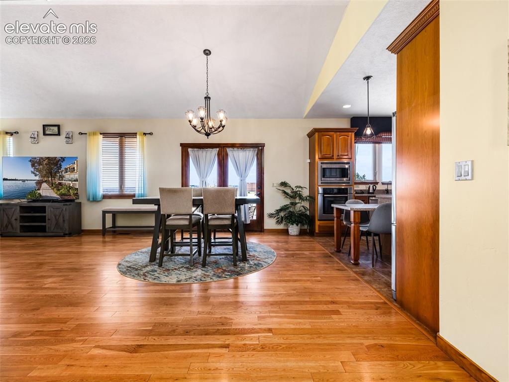 Image 2 of 44: Hardwood flooring throughout, recessed lighting, and a kitchen featuring wo