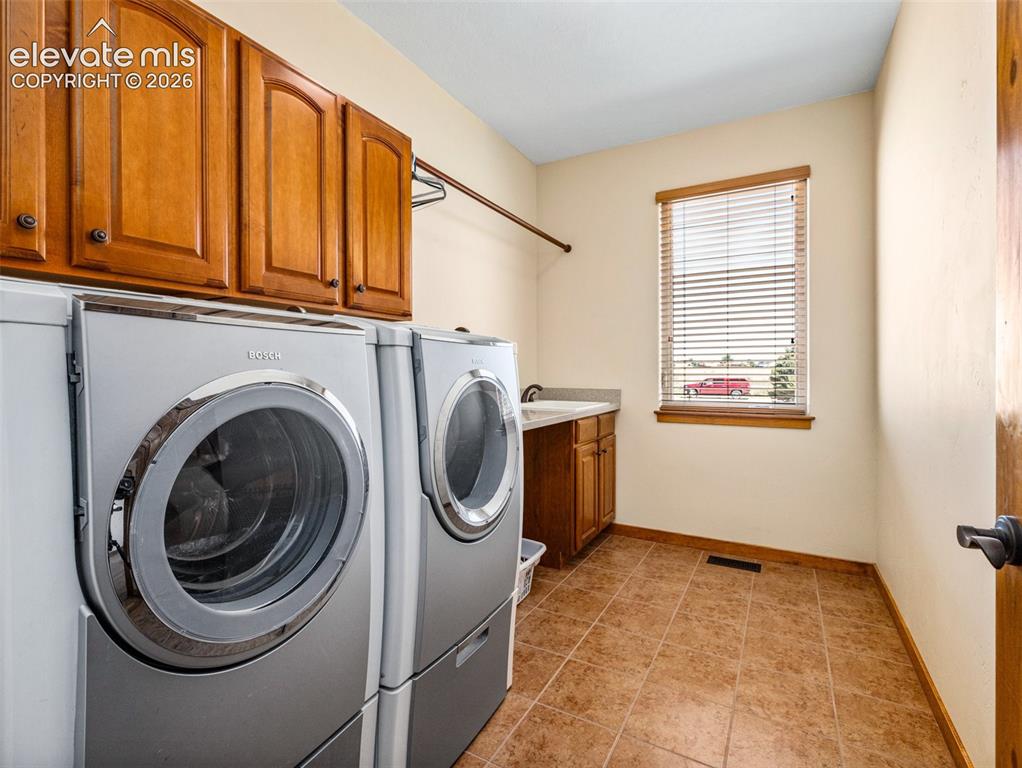 Image 21 of 44: Ceramic tile flooring, wood cabinetry, built-in sink, and window with blind