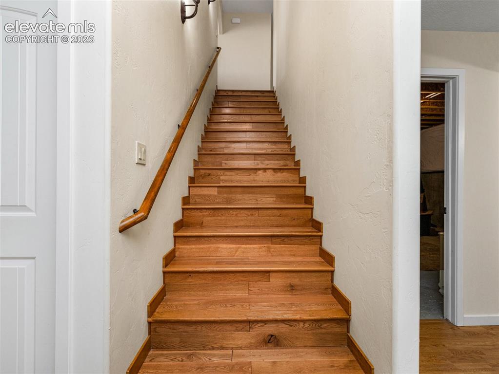 Image 25 of 44: Wood-finish staircase with a coordinating wood handrail