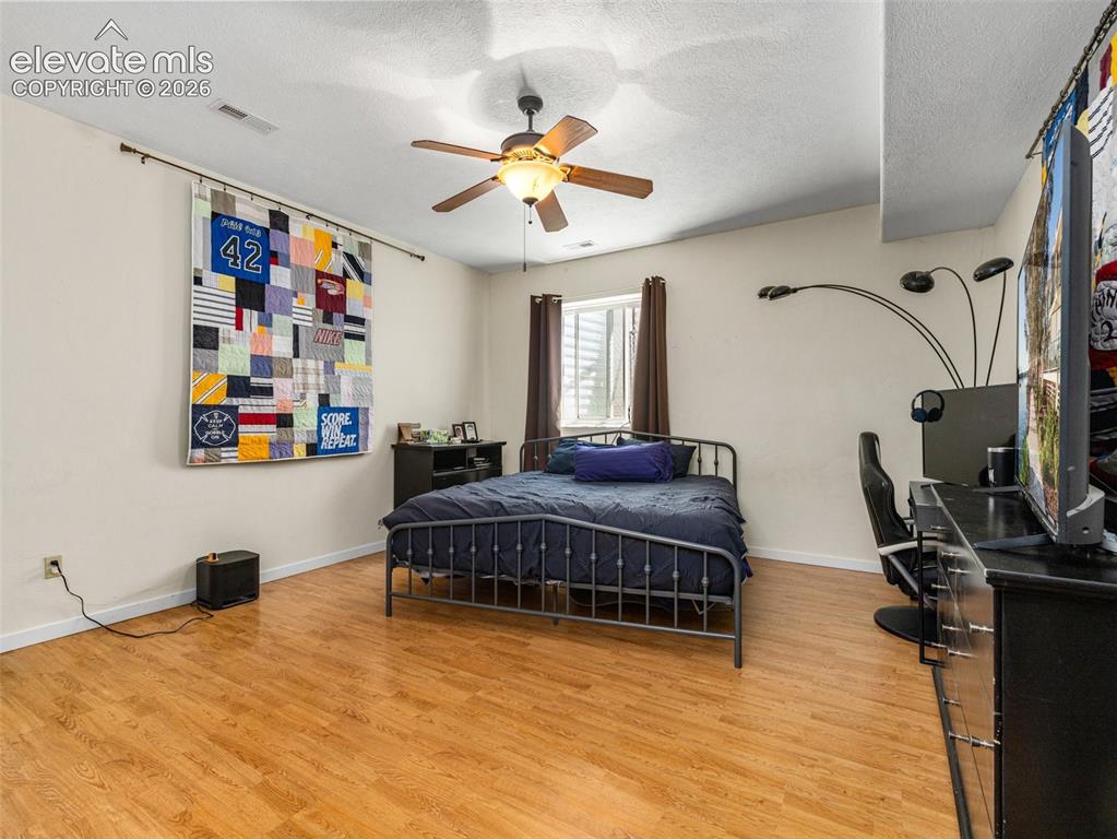 Image 28 of 44: Light-toned wood-finish flooring complements neutral wall paint