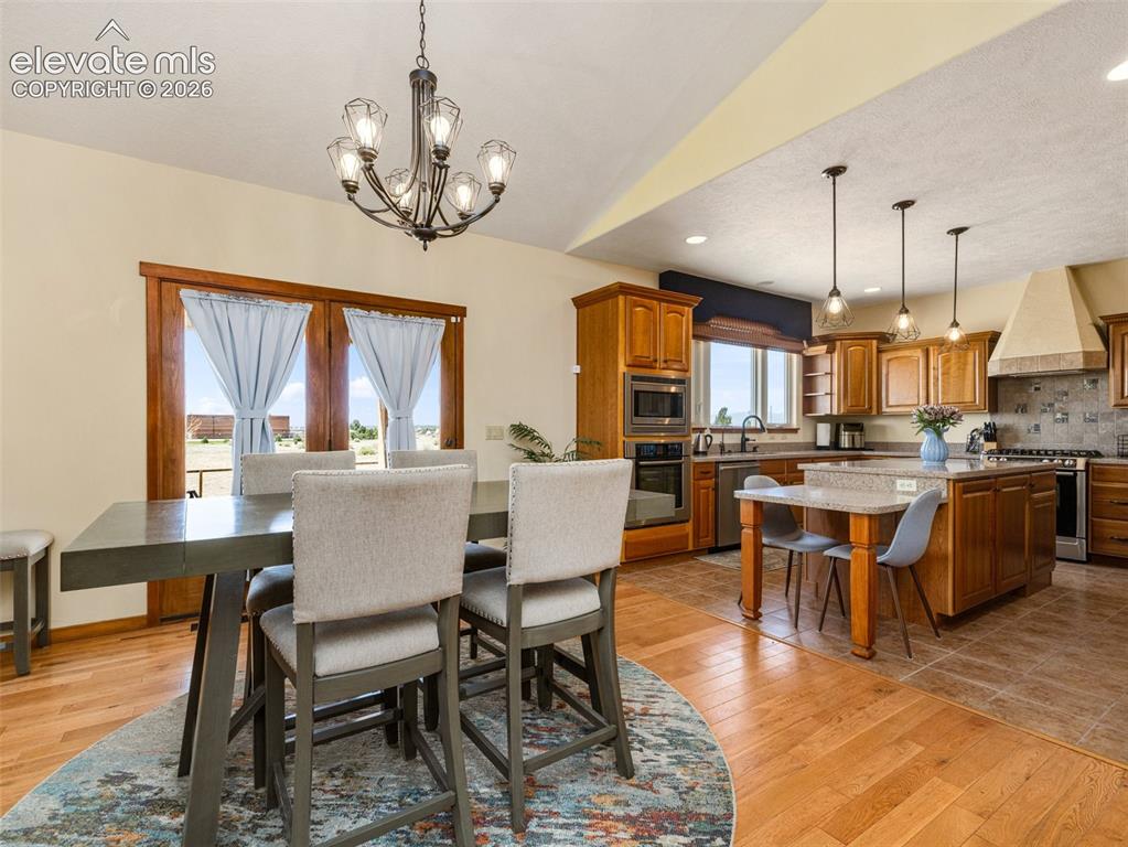 Image 3 of 44: Hardwood flooring, kitchen island with granite countertop, stainless steel 