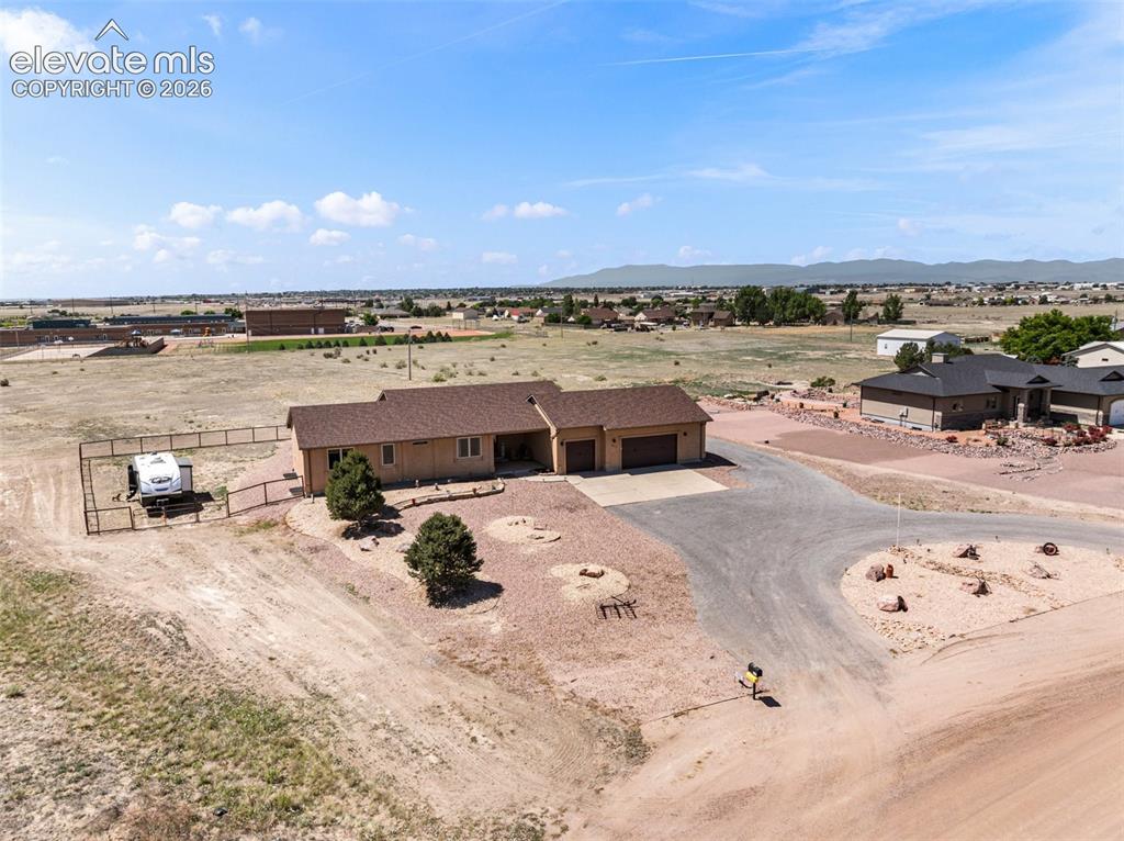 Image 35 of 44: Ranch-style residence featuring an attached two-car garage, expansive drive