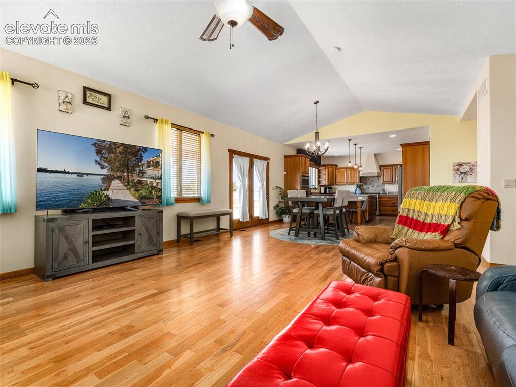 Image 8 of 44: Vaulted ceiling with a ceiling fan, wood-finish flooring, and French doors