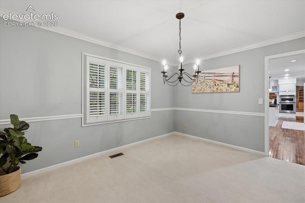 Image 10 of 49: Formal Dining rom off of Kitchen