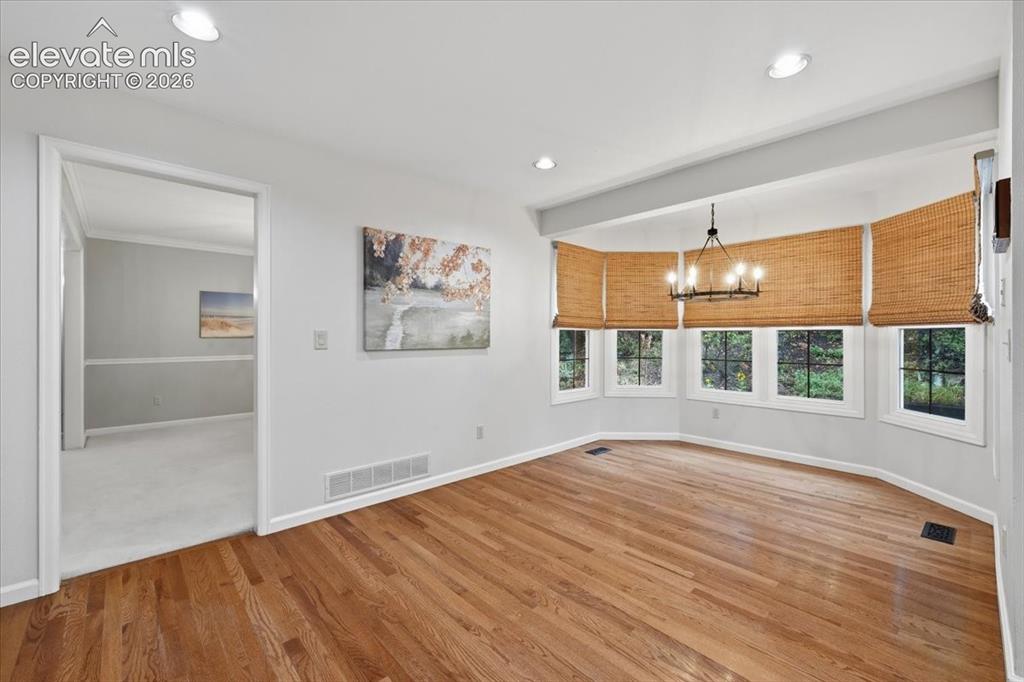 Image 11 of 49: large additional dining area in kitchen, fits 52 inch round table and chair