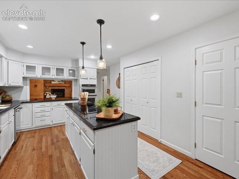 Image 14 of 49: Newly painted cabinets and knobs, sink and faucet, all new paint on backwal