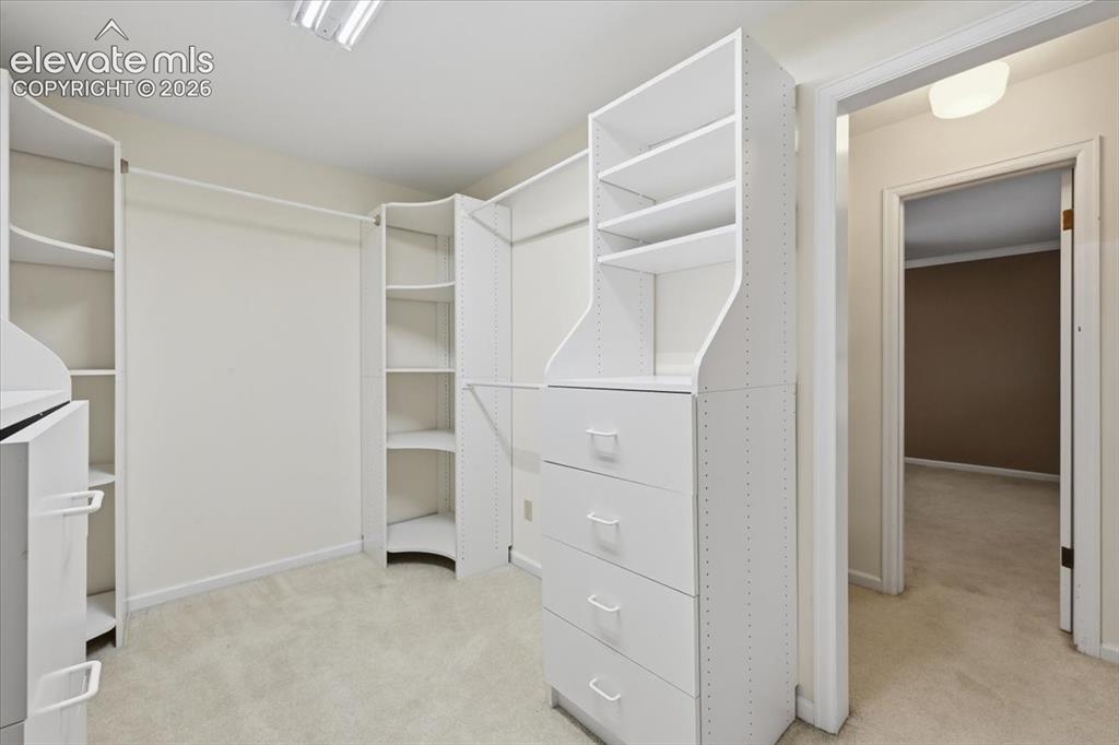 Image 25 of 49: Primary bedroom HUGE walk in closet the size of a small room