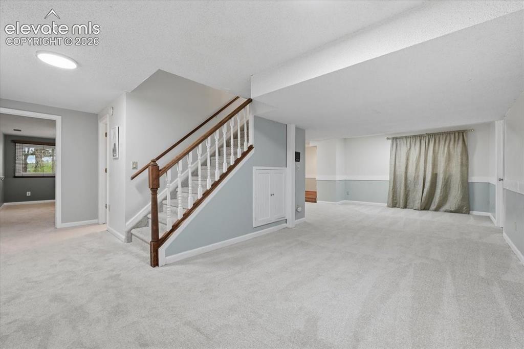 Image 33 of 49: Basement viewtowards bedbrrom, bathroom and open area