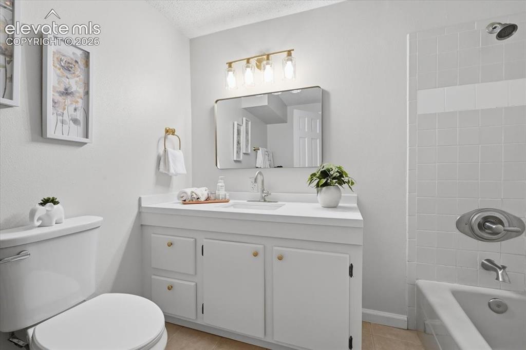 Image 35 of 49: Basement bathroom updated with new shelved, toilet, cabinet painted with ne
