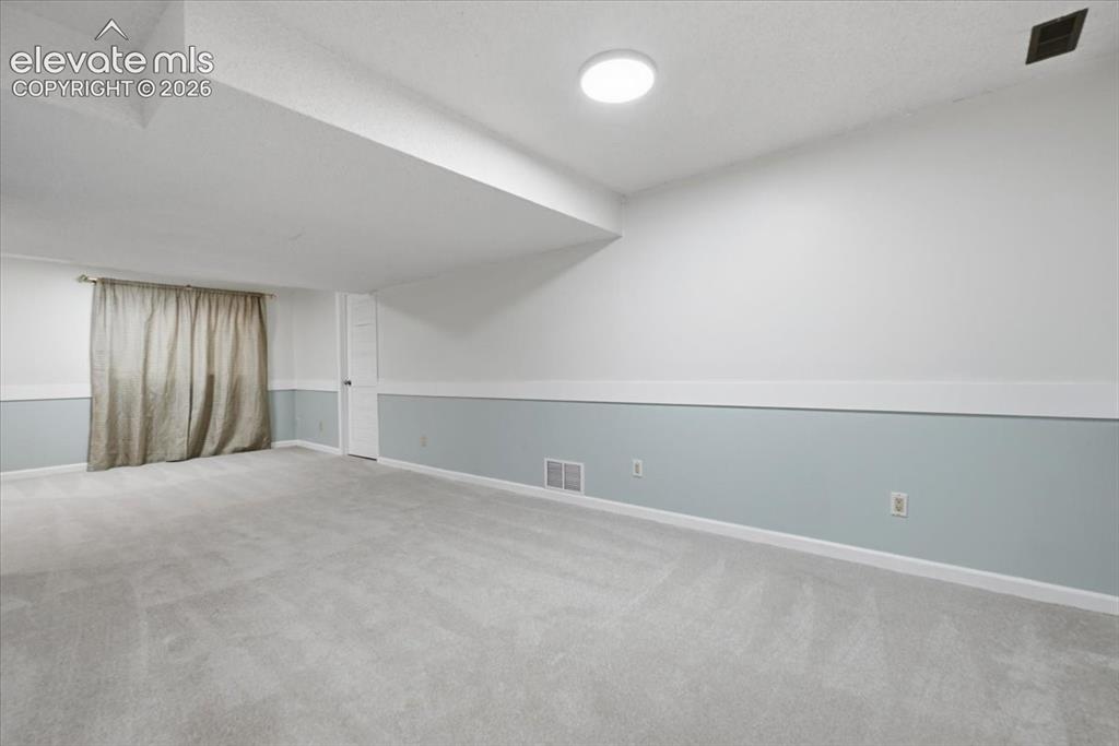 Image 39 of 49: Recreation area of basement Door to starage area