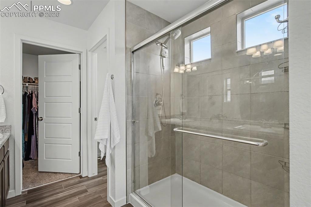 Image 16 of 28: Primary Bathroom with Walk-In Closet & Shower