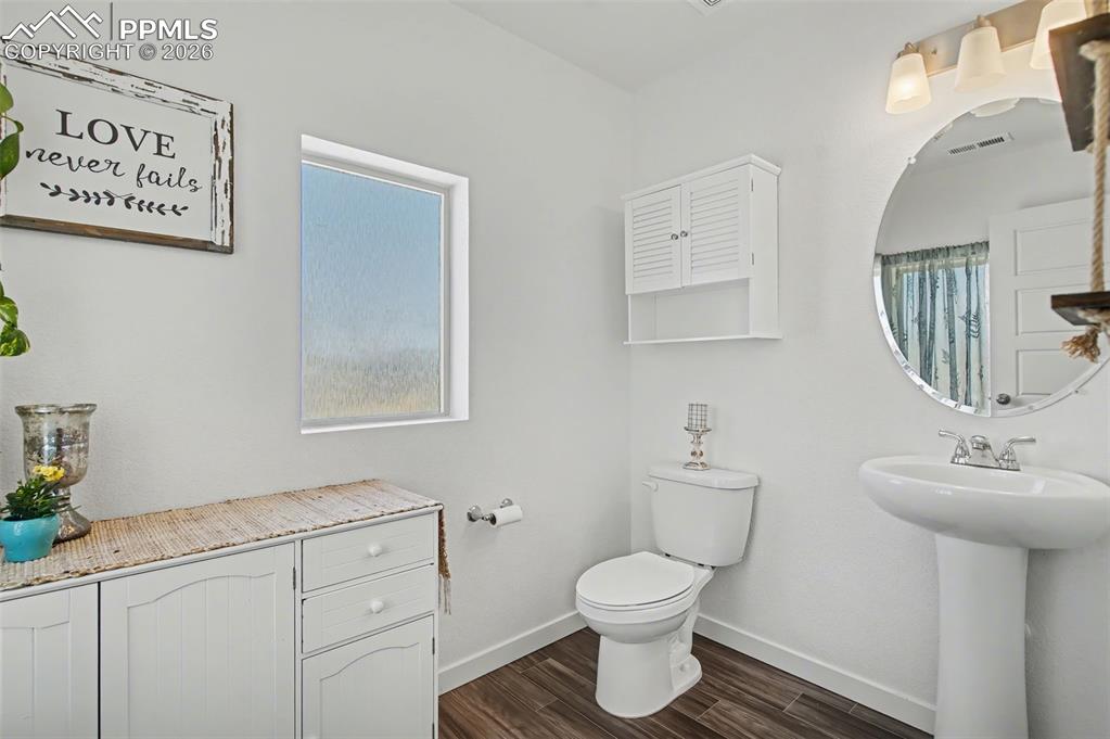 Image 21 of 28: Half Bathroom, off Living Room