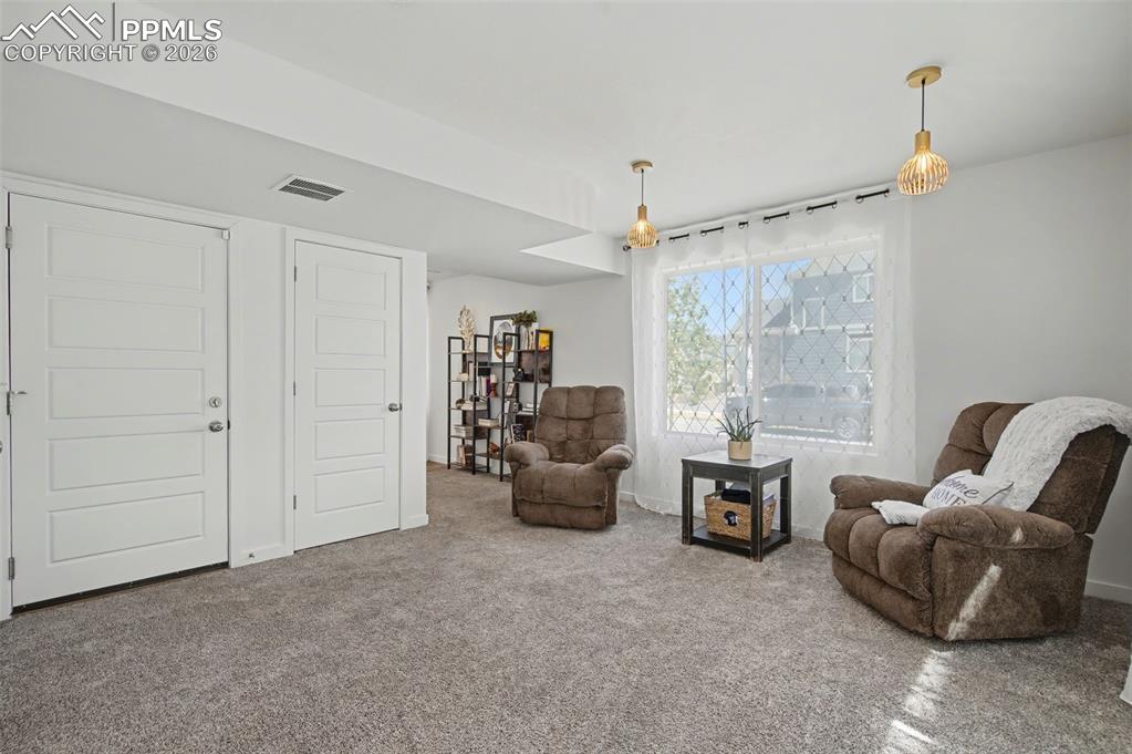 Image 22 of 28: Family Room on Main Level with Door to Garage