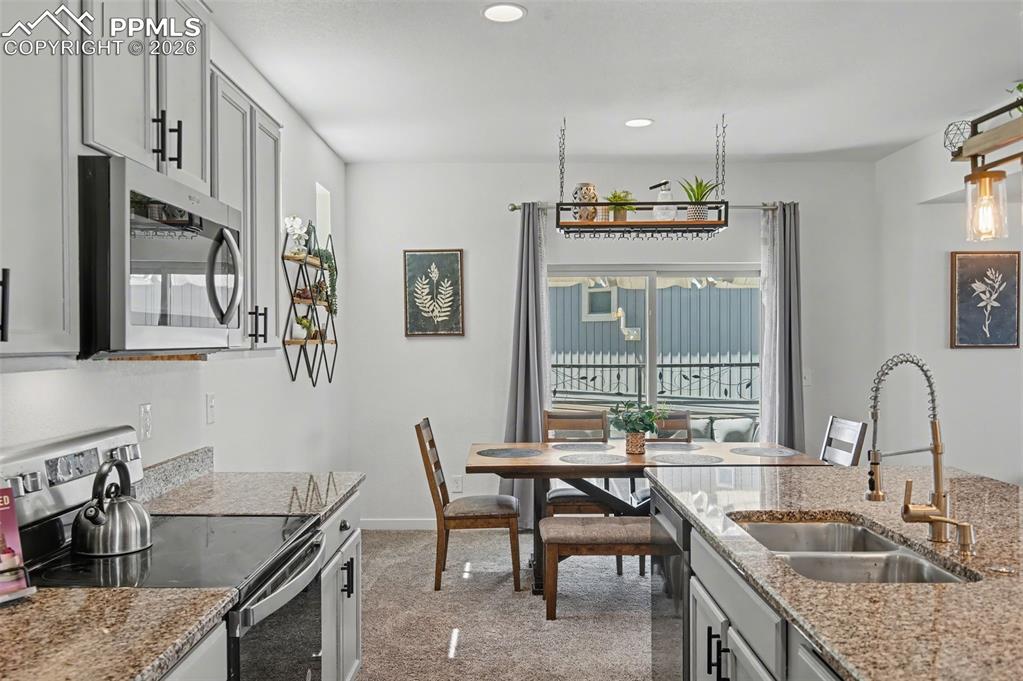 Image 5 of 28: Kitchen with View of Dining Room & Deck
