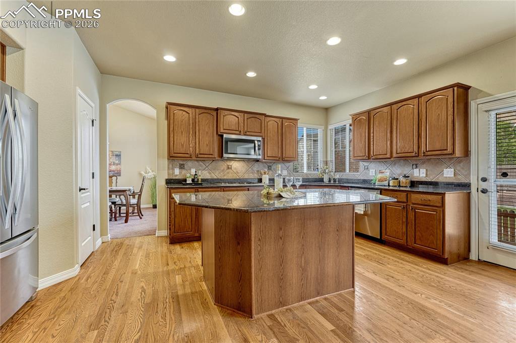 Image 12 of 50: An open-concept kitchen layout allows you to prep meals at the large granit