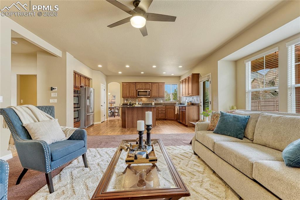 Image 17 of 50: Unwind after a long day in this light-filled family room anchored by a gas 