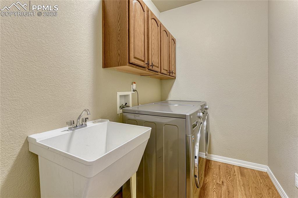 Image 22 of 50: Positioned away from the main living areas, this sunlit workspace with qual