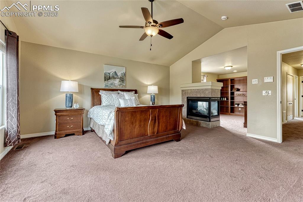 Image 26 of 50: Retreat to your oversized primary suite, featuring a stunning three-sided f