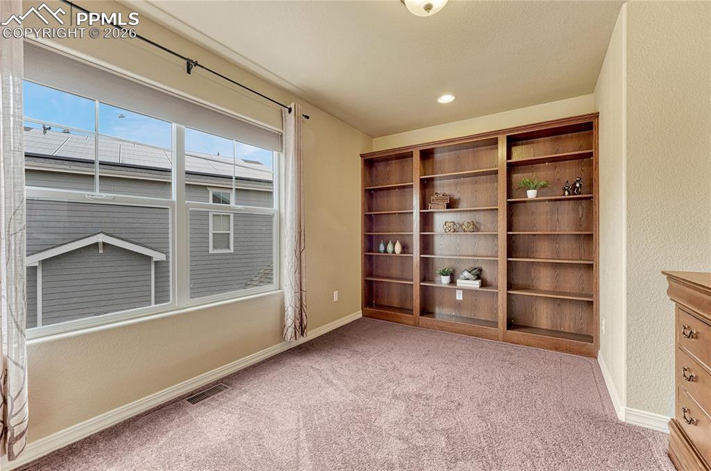 Image 27 of 50: Wake up to abundant natural light that instantly make this spacious bedroom