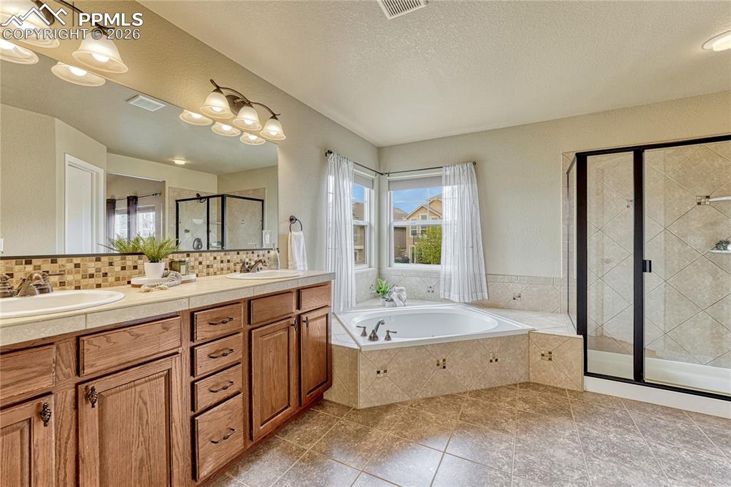 Image 29 of 50: Custom built-in shelving in the primary suite provides a sophisticated way 