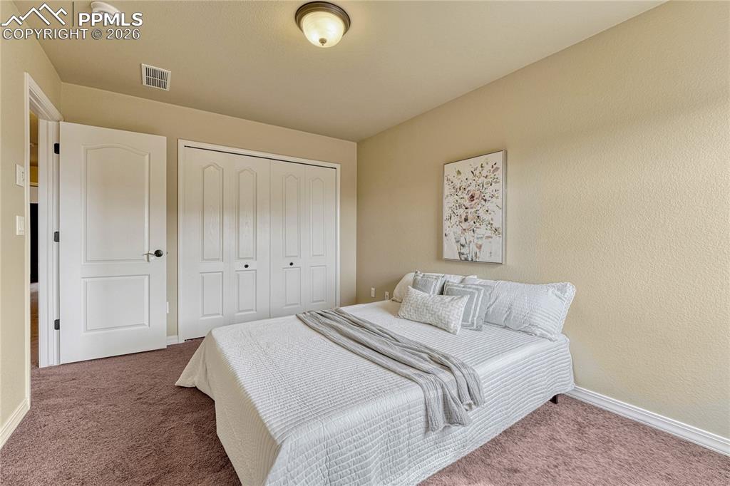 Image 33 of 50: This second upper-level bedroom offers generous closet space and is ready f