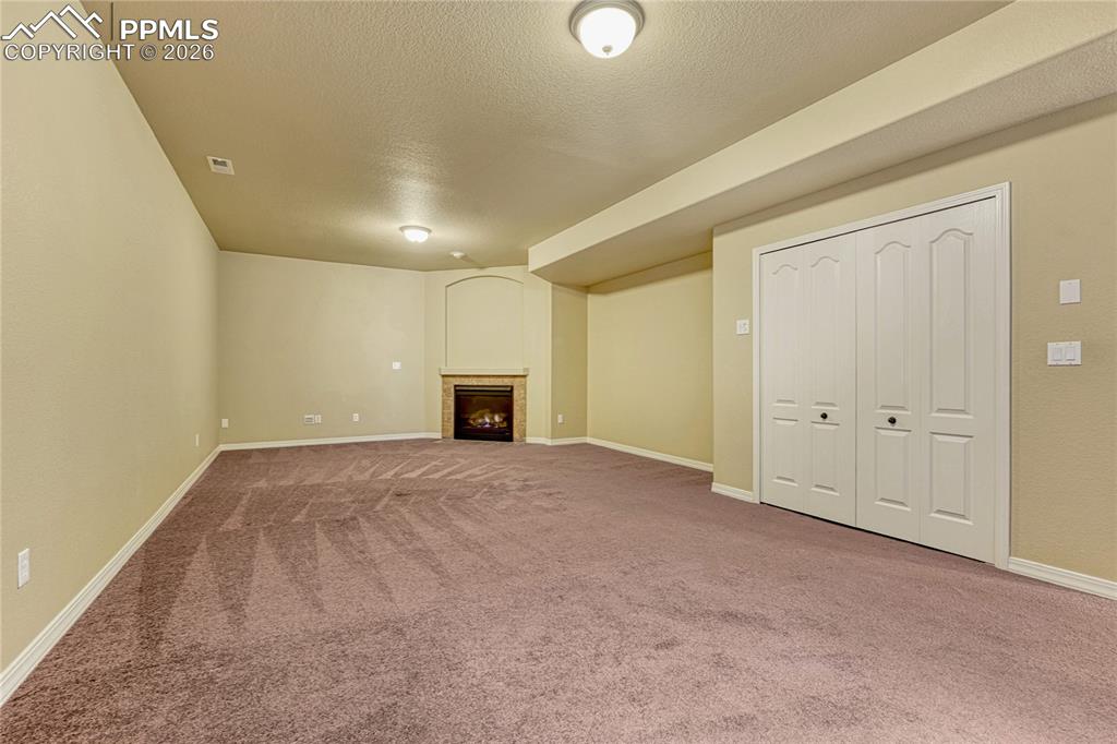 Image 36 of 50: Heading downstairs you’ll notice this convenient built-in wet bar, ensuring