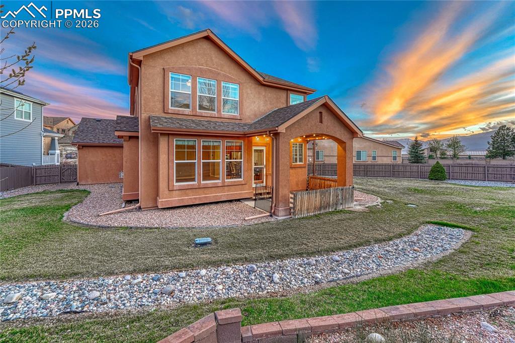 Image 45 of 50: Enjoy mornings and evenings under the thoughtfully designed covered patio, 