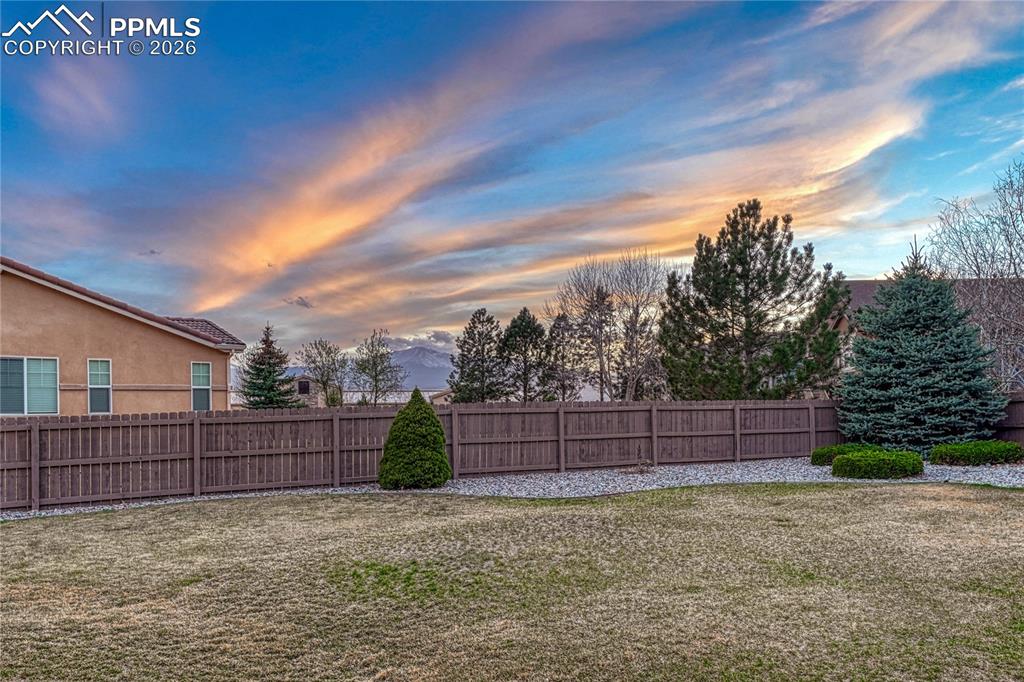 Image 47 of 50: Enjoy vibrant sunsets and views of Pikes Peak from your fully fenced-in bac