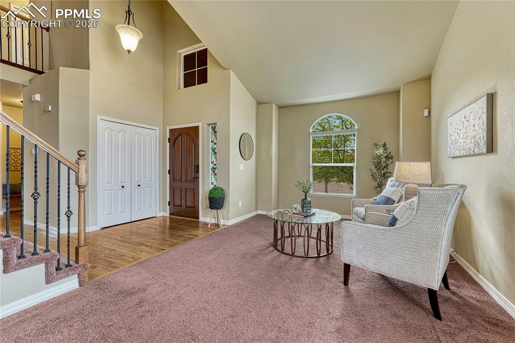 Image 5 of 50: The covered front patio area invites you into the home with warm archways a