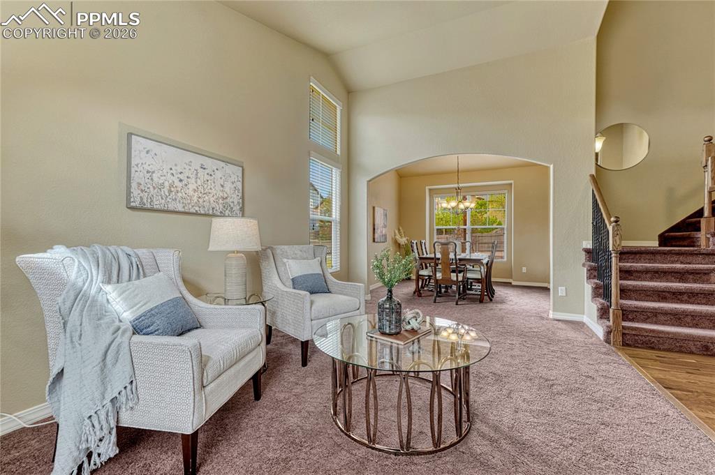 Image 7 of 50: Flooded with natural light, this front living area serves as the perfect su