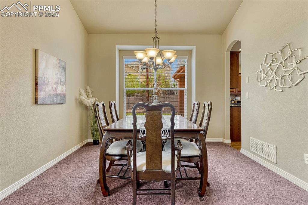 Image 9 of 50: The front living room connects to the formal dining space
