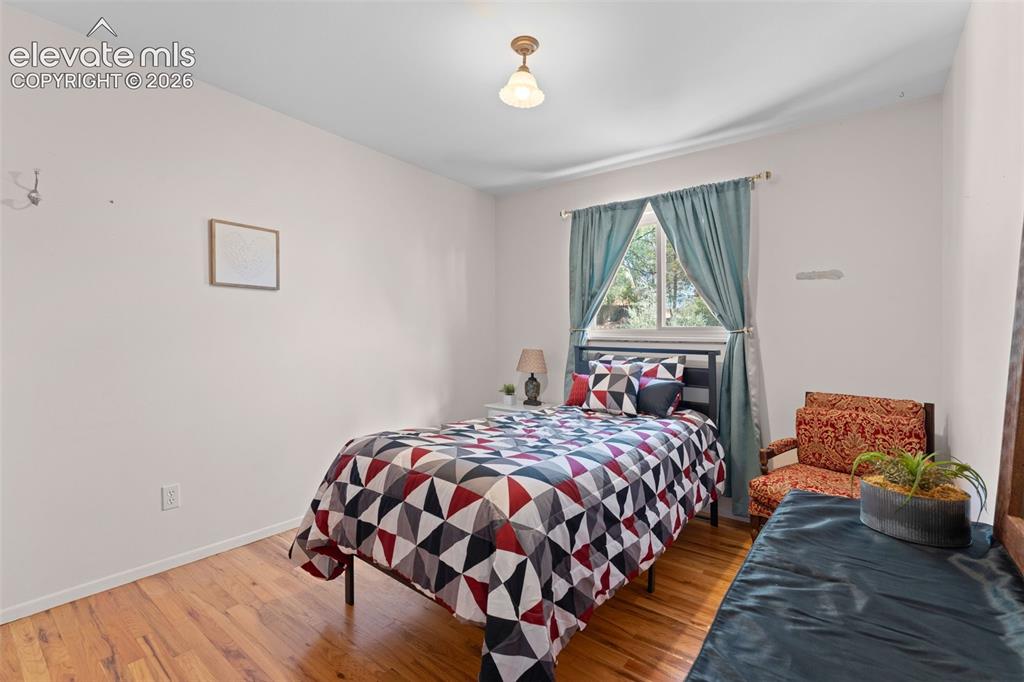 Image 18 of 50: Hardwood-finish flooring, recessed window with light-filtering drapes, ceil