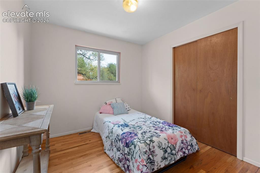 Image 21 of 50: Hardwood flooring, natural light through a single window, white painted wal