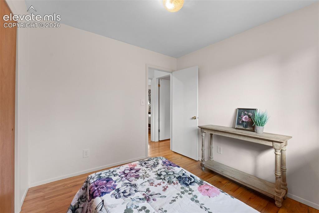 Image 25 of 50: Hardwood flooring throughout, white interior walls, and an overhead light f