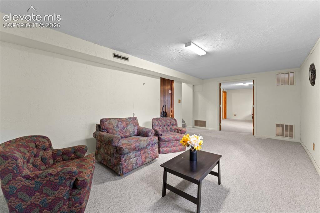 Image 36 of 50: Carpeted flooring throughout, recessed lighting, and a doorway leading to a