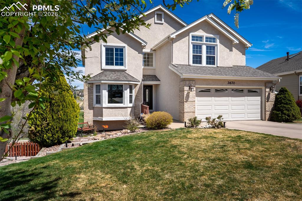 Image 1 of 50: Stucco exterior featuring a two-car garage with transom windows