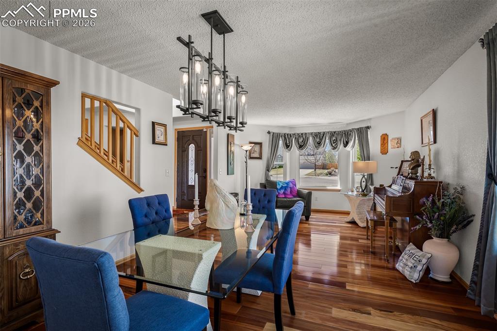 Image 15 of 50: Open-concept dining area featuring Brazilian Koa Hardwood flooring, a moder