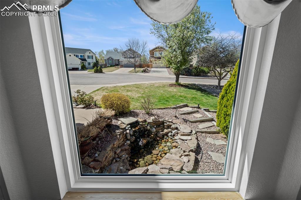 Image 19 of 50: Great view of front lawn water feature from livingroom bay window.
