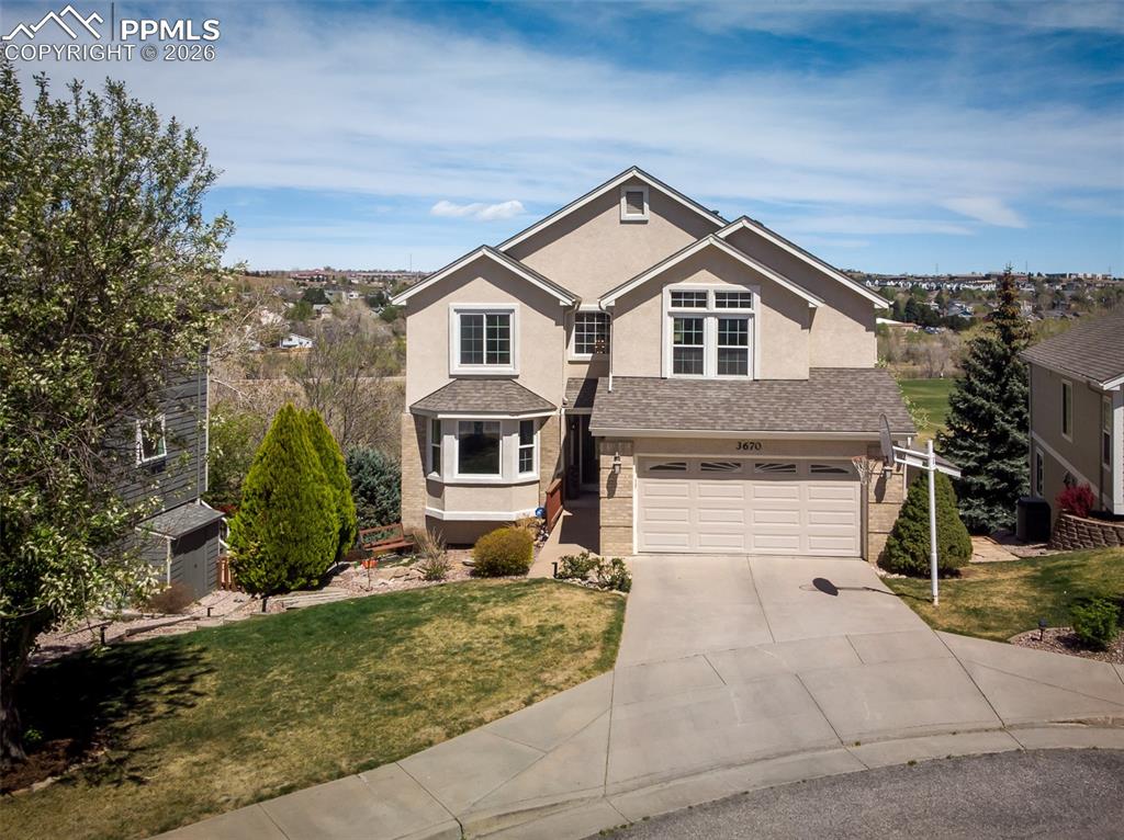 Image 2 of 50: Stucco exterior with brick accents and Cottonwood Park in the background.