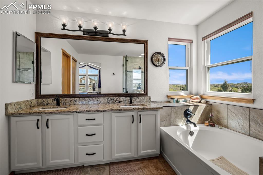 Image 33 of 50: Double vanity with quartz countertops, dual under-mount sinks, and matte bl