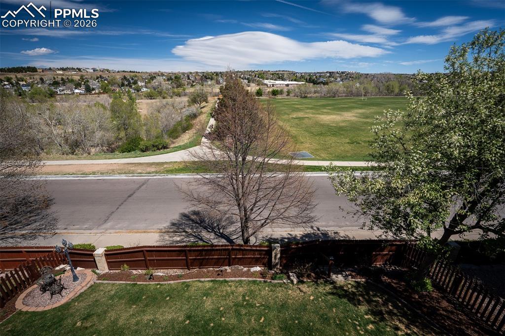 Image 41 of 50: Expansive green space and distant residential areas under a clear sky from 