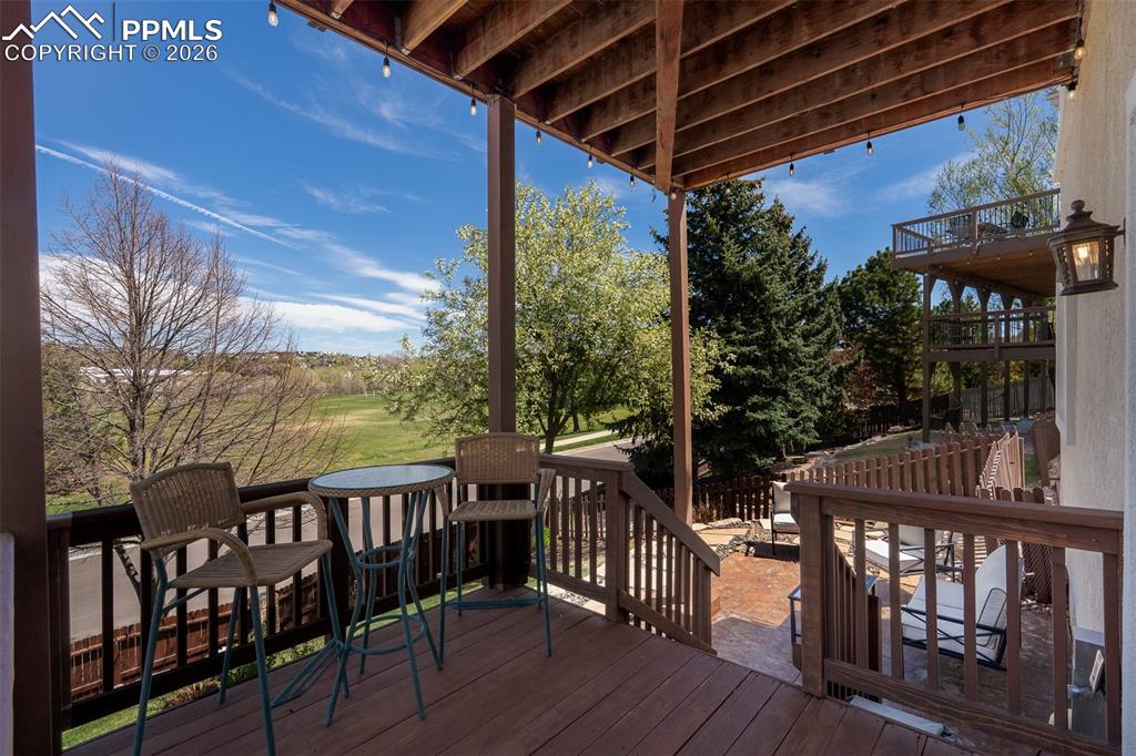 Image 43 of 50: Walk out lower level onto the lower deck featuring dark wood railing, expos