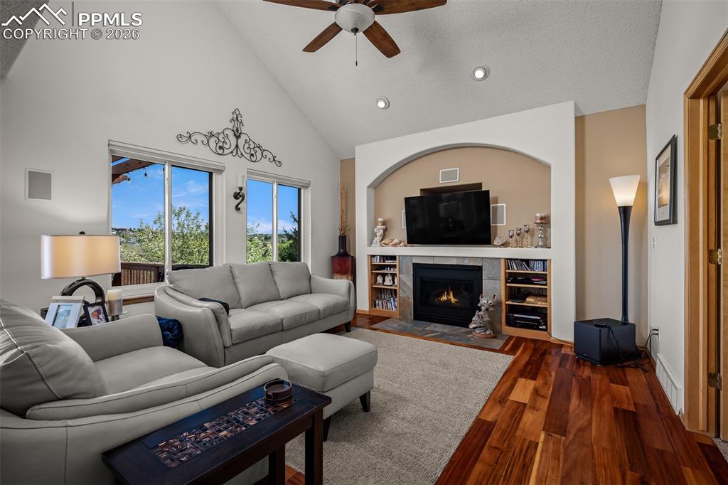 Image 6 of 50: Vaulted ceiling family area featuring rich Brazilian Koa hardwood flooring,