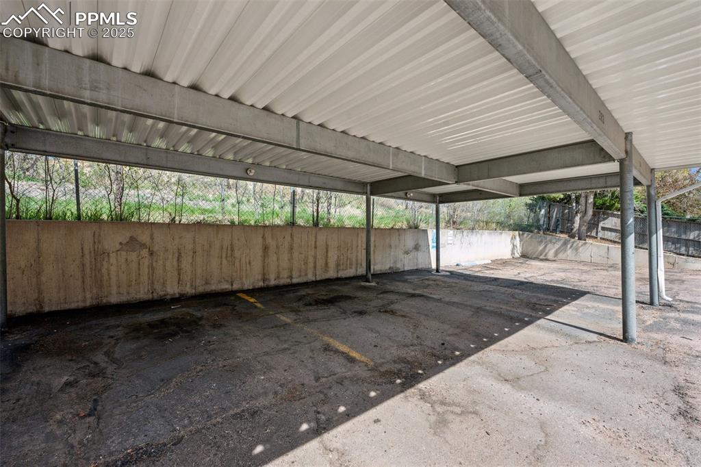 Image 11 of 11: Covered carport parking located conveniently behind the building.